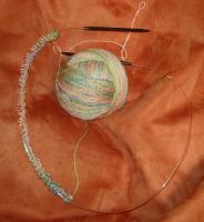 I stretch the cast-on row a bit after this point, and the woven-in strand relaxes and settles into place.